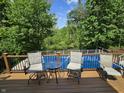 Deck overlooking wooded area, pool and river includes a table and chairs to relax and enjoy the scenic view at 6605 Donnelly Dr, Brownsburg, IN 46112
