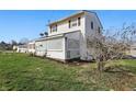 Angle view of charming house with lattice porch and side yard at 180 N Highland St, Morgantown, IN 46160