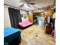 Cozy living room with original hardwood floors and wood paneling at 180 N Highland St, Morgantown, IN 46160