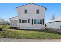 Rear view of two-story house with symmetrical windows and tidy lawn at 180 N Highland St, Morgantown, IN 46160