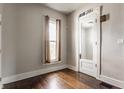 Bright bedroom with hardwood floors, window with natural light, and classic trim details at 2036 N Talbott St, Indianapolis, IN 46202