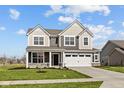 Charming two-story home with gray siding, white trim, and a well-kept lawn with a large two car garage at 4180 Bozeman Way, Bargersville, IN 46106