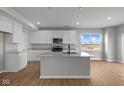 Modern kitchen features white cabinets, stainless steel appliances, a spacious island, and sleek countertops at 4180 Bozeman Way, Bargersville, IN 46106
