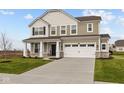 Charming two-story home with a two car garage and a covered entryway, surrounded by a well-maintained lawn and landscaping at 4186 Dutton Dr, Bargersville, IN 46106