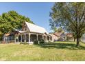 Charming home exterior with inviting front porch and mature trees in a lush yard at 741 Greer St, Indianapolis, IN 46203