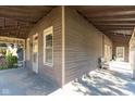 Inviting covered porch features windows and a seating area, perfect for relaxing at 741 Greer St, Indianapolis, IN 46203