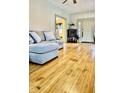 A cozy living room featuring hardwood floors and a comfortable gray couch, bathed in natural light, and neutral wall paint at 617 Carlyle Pl, Indianapolis, IN 46201