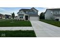 Two-story house with gray and beige siding, a large driveway, and a neatly landscaped lawn at 1191 Taggart Way, Greenwood, IN 46143