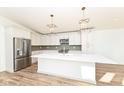 Modern kitchen with white cabinets and large island at 4902 N Park Ave, Indianapolis, IN 46205
