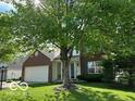 Attractive home exterior with lush lawn and large trees offering shade, perfect for curb appeal at 534 Austrian Way, Avon, IN 46123