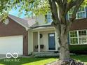 Inviting home facade with a porch swing and a brick front, enhanced by a lush lawn at 534 Austrian Way, Avon, IN 46123