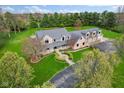 Aerial view of a sprawling home with lush greenery, mature trees, and meticulously maintained landscaping at 5911 N 400 W, Bargersville, IN 46106