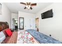 Bright bedroom with king bed, en-suite bathroom access, and TV at 6252 Sugar Maple Dr, Zionsville, IN 46077