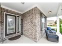 Inviting front porch with brick columns and comfortable seating at 6252 Sugar Maple Dr, Zionsville, IN 46077