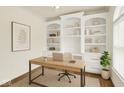 Bright home office featuring custom built-in shelving, modern desk, neutral decor, and plenty of natural light at 794 Princeton Ln, Westfield, IN 46074