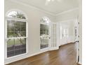 Sun-filled living room with wood floors, large windows, French doors, and white trim at 794 Princeton Ln, Westfield, IN 46074