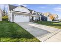 View of a single-Gathering home with a two-car garage and a well-maintained front lawn on a sunny day at 17871 Paula, Westfield, IN 46074
