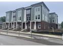 Modern townhomes showcase a brick base, white pillars, and a gray and white exterior paint scheme at 2609 E New York St, Indianapolis, IN 46201