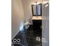 Modern bathroom featuring a sleek black marble floor, vanity, and toilet at 6362 Harmonridge Ct, Indianapolis, IN 46278