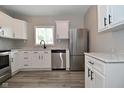 Modern kitchen with white cabinets, stainless steel appliances, and hardwood flooring at 1709 Hoyt Ave, Indianapolis, IN 46203
