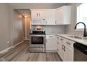 Well-equipped kitchen features stainless steel appliances, white cabinets, and sleek hardware at 1709 Hoyt Ave, Indianapolis, IN 46203