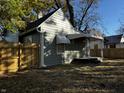 Backyard view with new wooden fence, lawn and walkway at 212 S Good Ave, Indianapolis, IN 46219