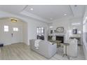 Bright living room features a fireplace, light wood floors, neutral decor, and a view to the home's entrance at 2639 Collins Dr, Westfield, IN 46074