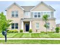 Charming two-story brick home featuring a well-manicured lawn and a welcoming entrance at 5778 W Commonview Dr, McCordsville, IN 46055