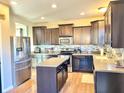 Modern kitchen features stainless steel appliances, a center island, and stylish backsplash at 5778 W Commonview Dr, McCordsville, IN 46055