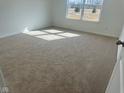 Bright bedroom with new carpeting, neutral walls, base trim, and a large window allowing ample natural light at 6629 Sulgrove Pl, Indianapolis, IN 46221