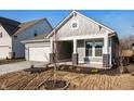 Charming single-story home with gray siding, white trim, and a two-car garage at 14293 Coyote Ridge Dr, Noblesville, IN 46060