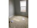 Grey walled bedroom with a window providing natural light in an unfinished space at 1439 Wigwam Ln, Martinsville, IN 46151