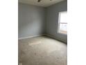 Unfinished bedroom with a window providing natural light and grey painted walls at 1439 Wigwam Ln, Martinsville, IN 46151