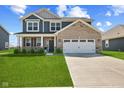 Charming two-story home with manicured lawn and a two-car garage at 1775 Beyers St, Fortville, IN 46040