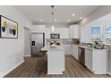 Bright kitchen with white cabinets, stainless steel appliances and a large island at 1775 Beyers St, Fortville, IN 46040