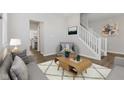 Cozy living room with gray furniture, wood floors and a staircase at 1775 Beyers St, Fortville, IN 46040