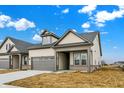 Attractive beige single-Gathering home with a covered entryway, a two-car garage, and a well-maintained gray roof at 18322 Depoe Ln, Westfield, IN 46074