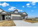 Beautiful single-Gathering home featuring a gray roof, neutral siding, and an attached two-car garage at 18322 Depoe Ln, Westfield, IN 46074