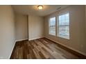 A bright bedroom with hardwood floors and two large windows allowing plenty of natural light at 12020 Gia Ct, Noblesville, IN 46060