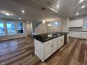 Open-concept kitchen features a large island with bar seating and stainless steel dishwasher at 12020 Gia Ct, Noblesville, IN 46060