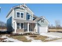 Two-story craftsman style home with a white garage door and landscaping at 14309 Coyote Ridge Dr, Noblesville, IN 46060
