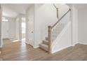 A view of a staircase with carpeted steps and wooden railing at 14309 Coyote Ridge Dr, Noblesville, IN 46060