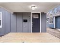Inviting front porch featuring a modern black door and stylish overhead lighting at 1829 New St, Indianapolis, IN 46203