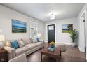 Bright living room with neutral decor, hardwood floors, and decorative artwork at 1829 New St, Indianapolis, IN 46203