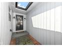 Covered entryway with a skylight, and storm door, with an outdoor water spigot at 8528 Quail Hollow Rd, Indianapolis, IN 46260