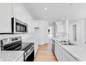 Contemporary kitchen with stainless steel appliances, white cabinets and marble countertops at 1095 Bevy Blvd, Danville, IN 46122