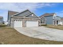 Stunning house with brick accents, a three-car garage, and a wide concrete driveway at 346 Limerick Ln, Pendleton, IN 46064