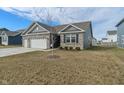 Lovely single Gathering home featuring gray brick, a well-kept lawn, and a spacious three-car garage at 346 Limerick Ln, Pendleton, IN 46064
