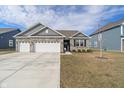 Beautiful single-story home with a spacious three-car garage and a neatly maintained lawn at 346 Limerick Ln, Pendleton, IN 46064