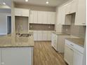 Spacious kitchen with white cabinets, granite countertops, and hardwood floors at 2331 Saddle Dr, Shelbyville, IN 46176
